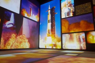 a room whose walls feature imagery of rocket launches
