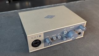 A top down, angled view of the Universal Audio Volt 1 audio interface on a desktop