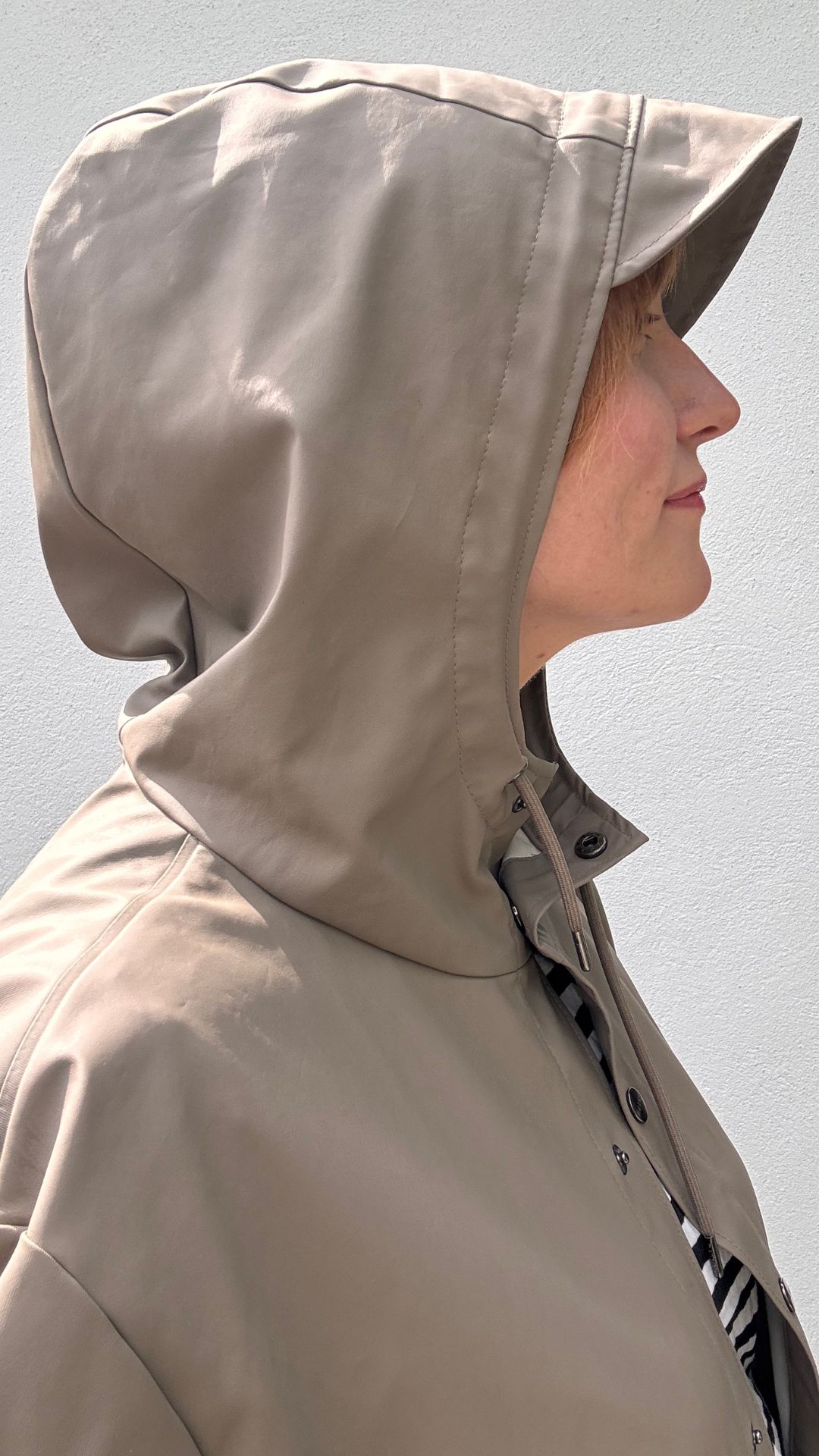 matilda wearing the rains jacket with hood up