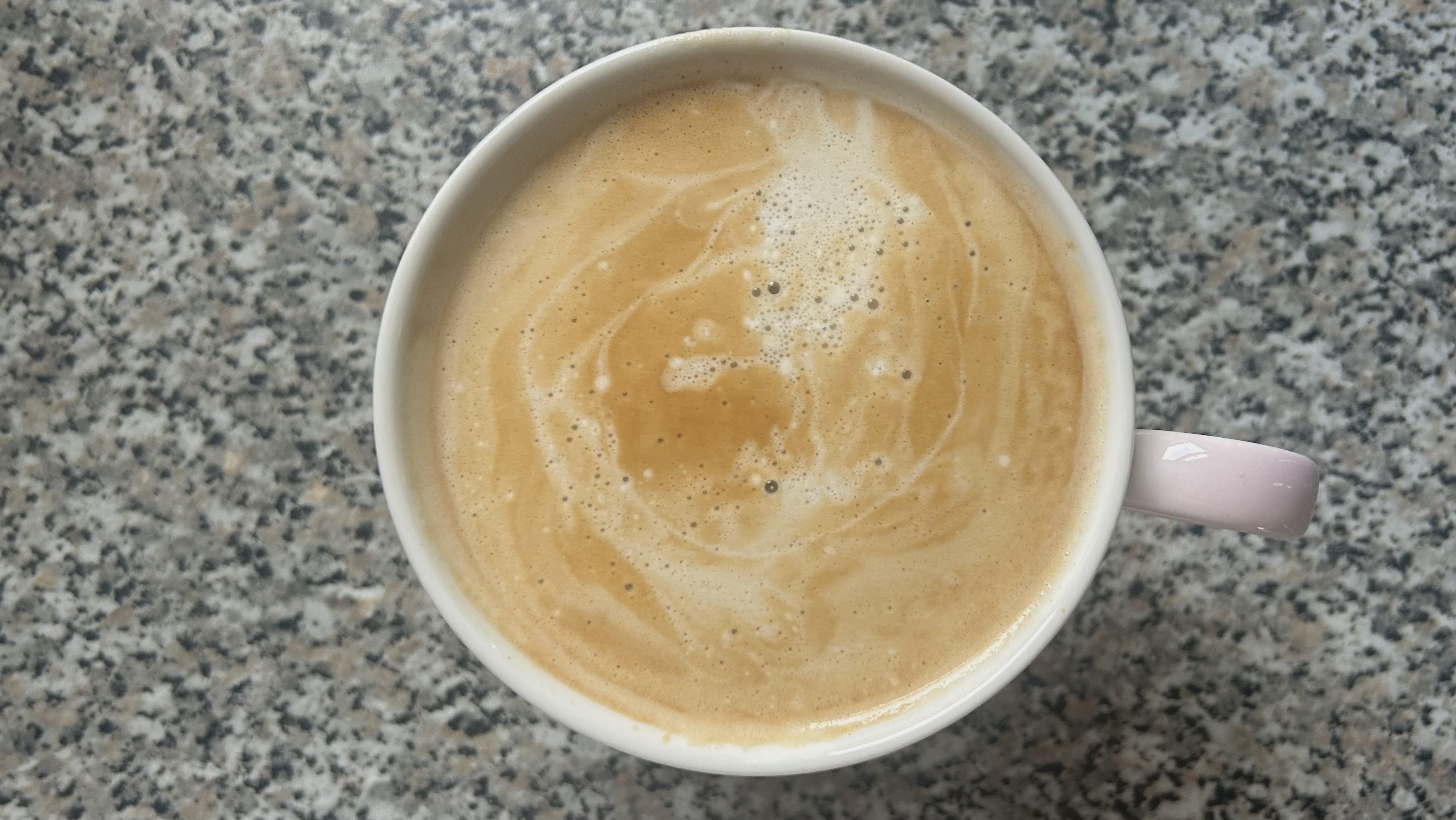 Foam on top of a latte made using the DeLonghi Dedica Duo.