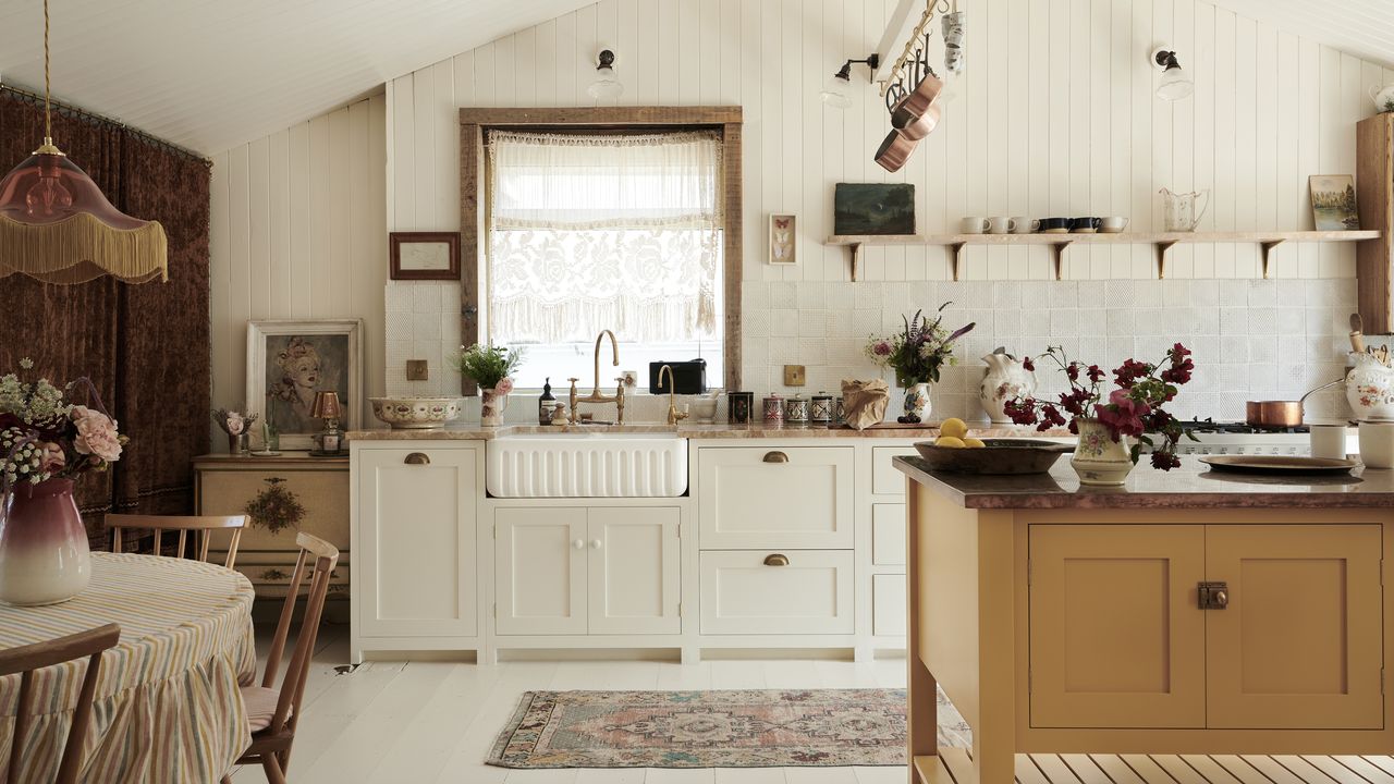 A white kitchen with off-white shaker cabinets, shiplap walls and white textured backsplash tiles 