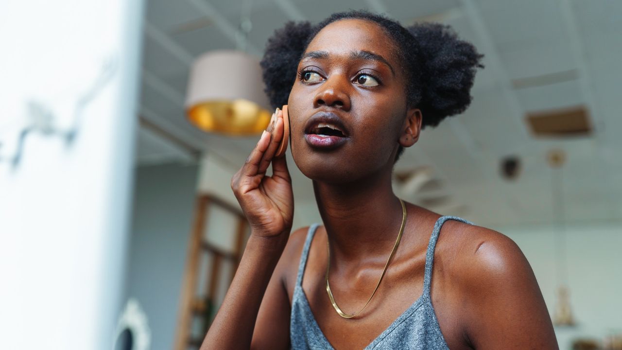 woman applying benzoyl peroxide to manage acne