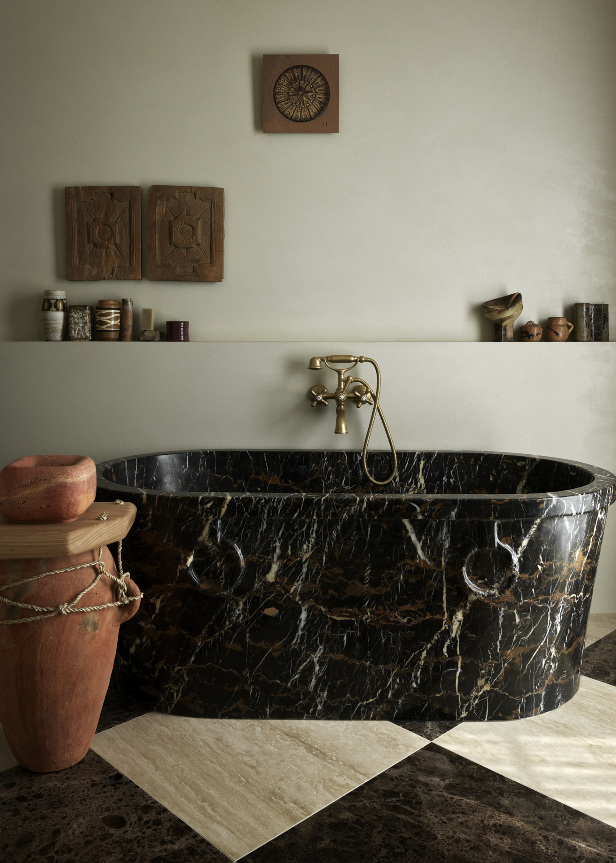dark marble freestanding bath with checkered floor
