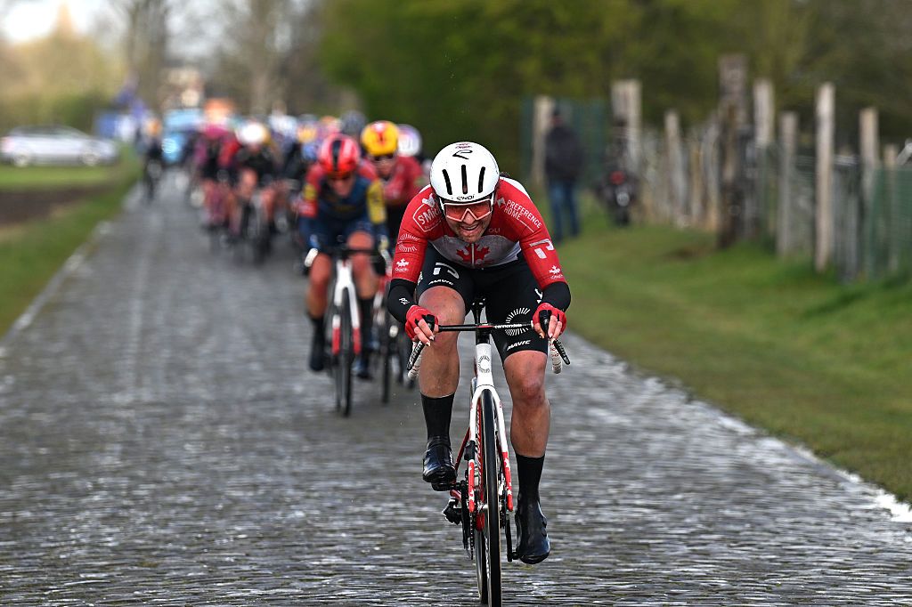Front on view of the Canadian champion with the peloton in a line behind