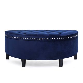 Royal blue Upholstered Flip Top in the shape of a semi circle, with wooden legs, button-back on top and silver rivets along the edge of the lid.