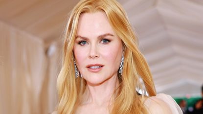 Nicole Kidman has long, golden blonde hair as she poses on the red carpet at the Met Gala 2023