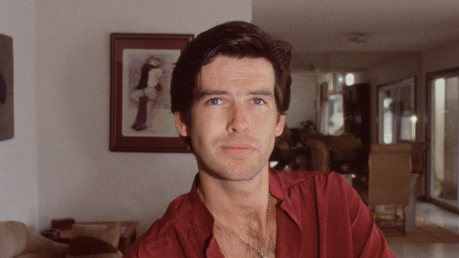 pierce brosnan in his '80s living room