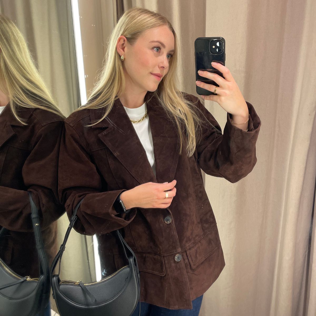Woman wears brown suede jacket