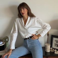 Julie wears high waisted skinny jeans and white blouse