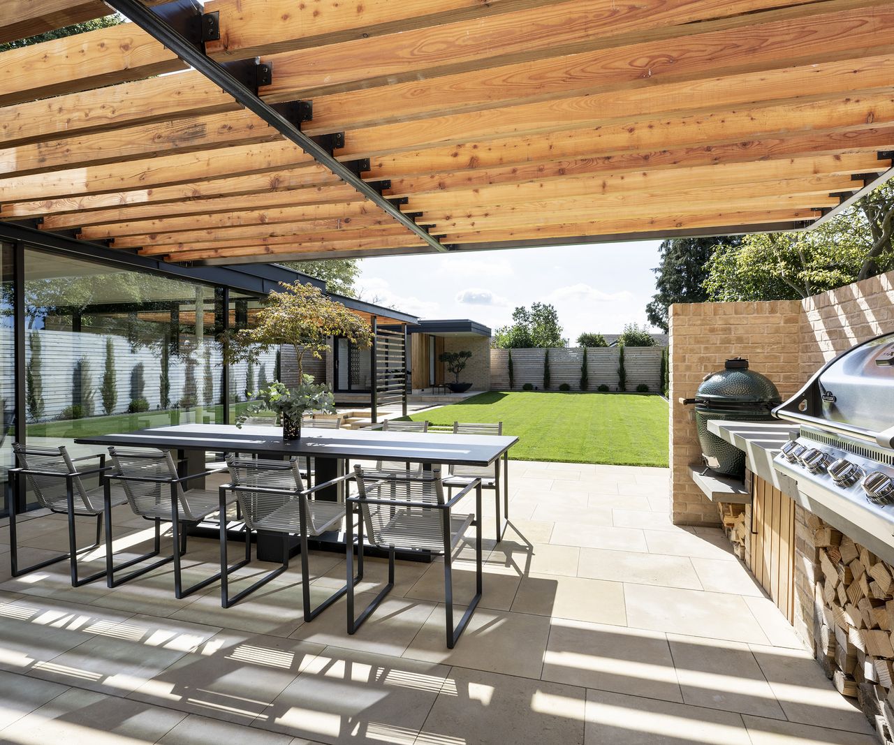Covered patio area with dining table and cooking area