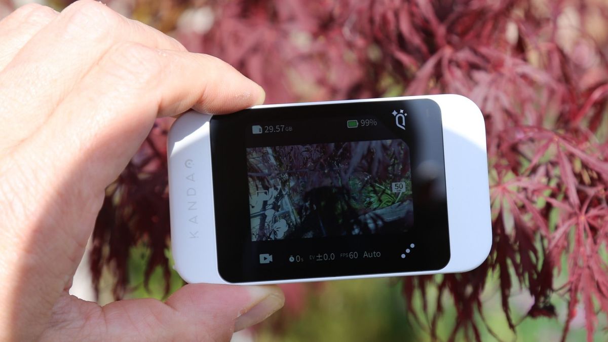 A hand holding the Kandao Qoocam Ego 3D camera