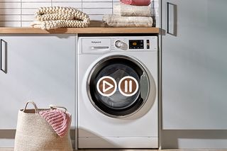 An image showing a Hotpoint washing machine with the stop and add feature enabled
