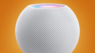 The Apple HomePod Mini on an orange background