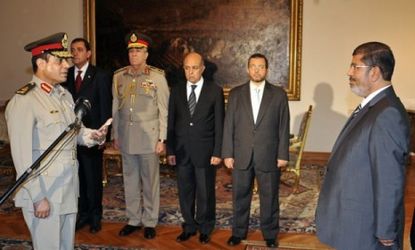 Egyptian President Mohamed Morsi swears in newly appointed Minister of Defense, Lt. Gen. Abdel Fattah el-Sissi, Aug. 12.