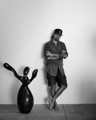 Rogan Gregory in his studio in Santa Monica next to a sculpture