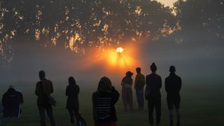 people watch the rising sun