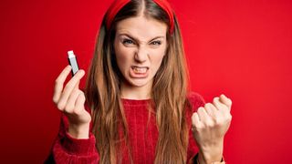 Angry woman holding a USB drive