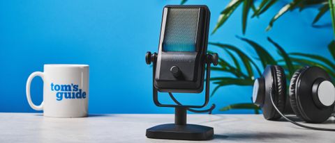 a small retro-inspired microphone with a large RGB sound capsule is photographed against a blue background