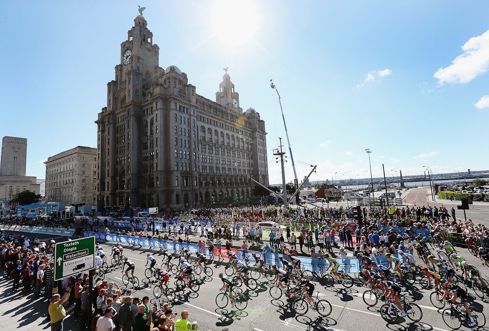 The peloton take a bend in front of the Liver Building on lap two during stage one of the Tour of Britain in Liverpool City Centre.