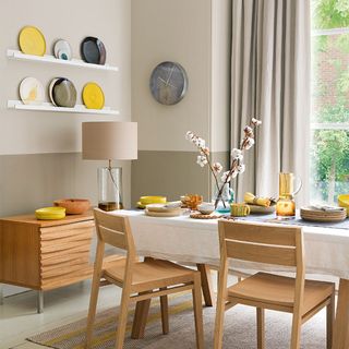A neutral dining room with wall storage and a plate rack