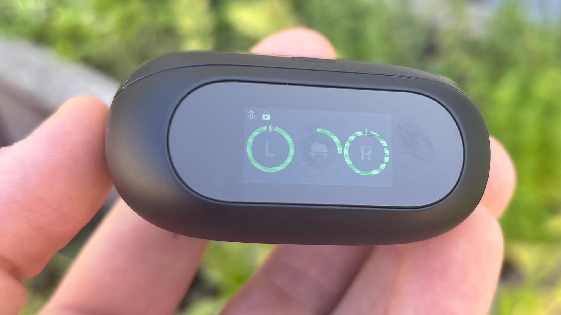 Soundcore Liberty 5 Pro in-ear headphones case held in hand showing display