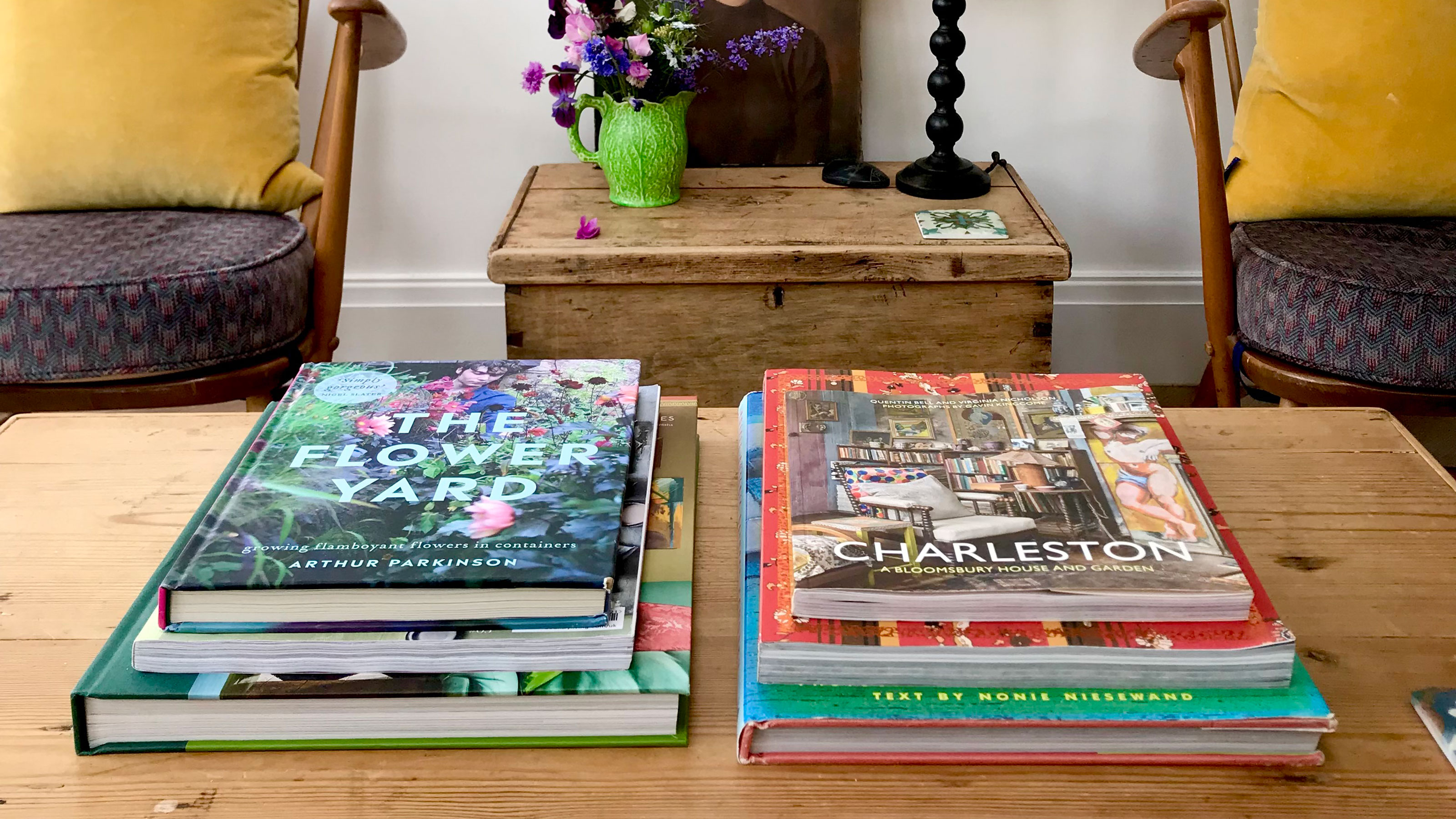 Wooden coffee table with two stacks of books
