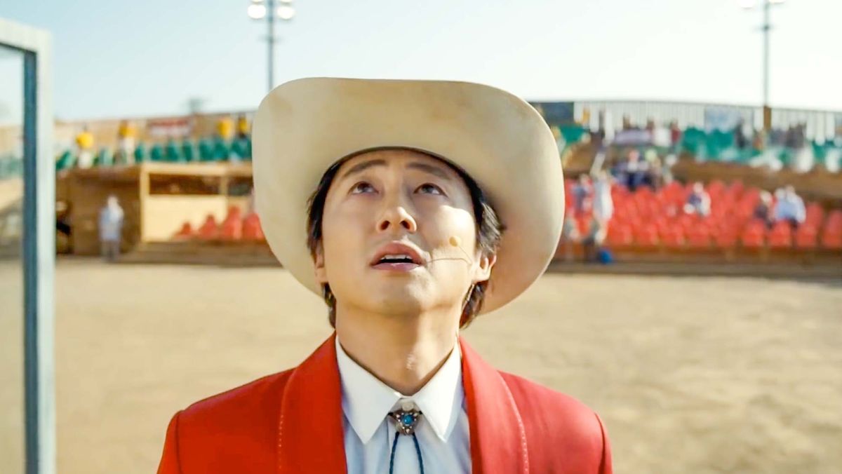 Steven Yeun as Ricky Park, looking up while performing for a crowd in Jordan Peele&#039;s Nope