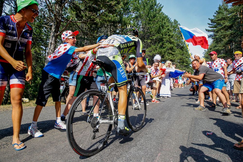 Alberto Contador climbs through the crowds.