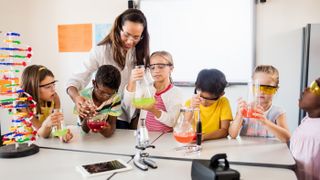 Kids follow the scientific method to carry out an experiment.