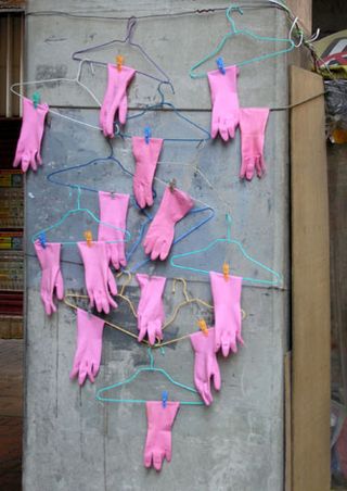 pink gloves on hangers