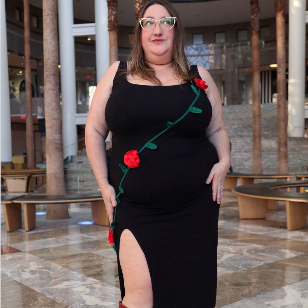 Sarah Chiwaya wearing a LBD with red rosettes