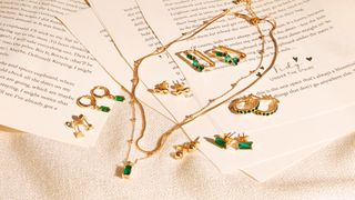 Superdrug Studio London Green Stone Double Layer Necklace and other jewelry laid out on a surface