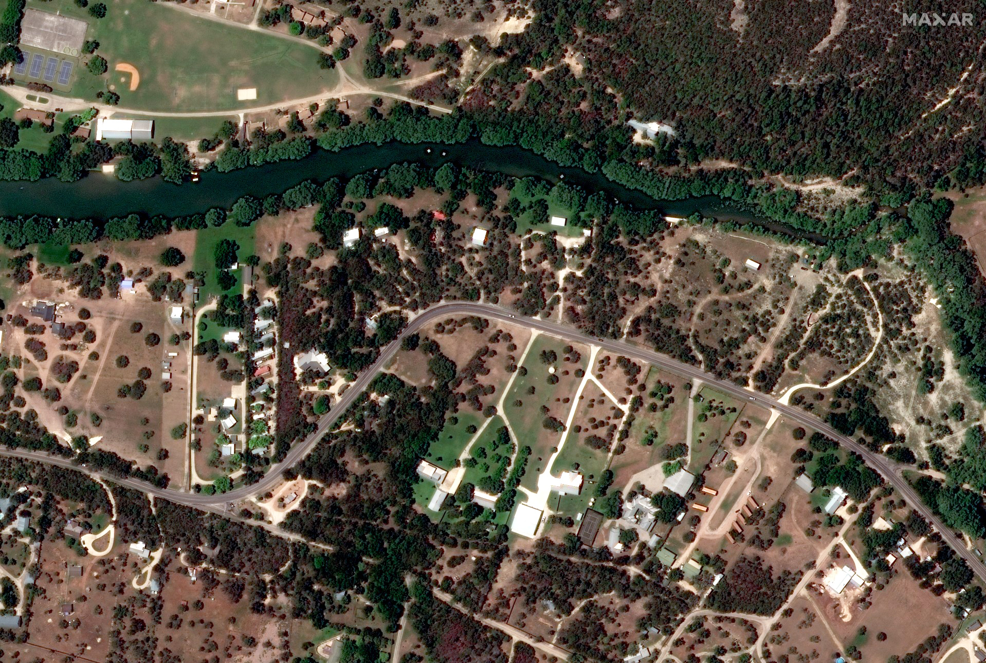 A satellite photograph showing homes beside the Guadalupe River on June 23, 2023.