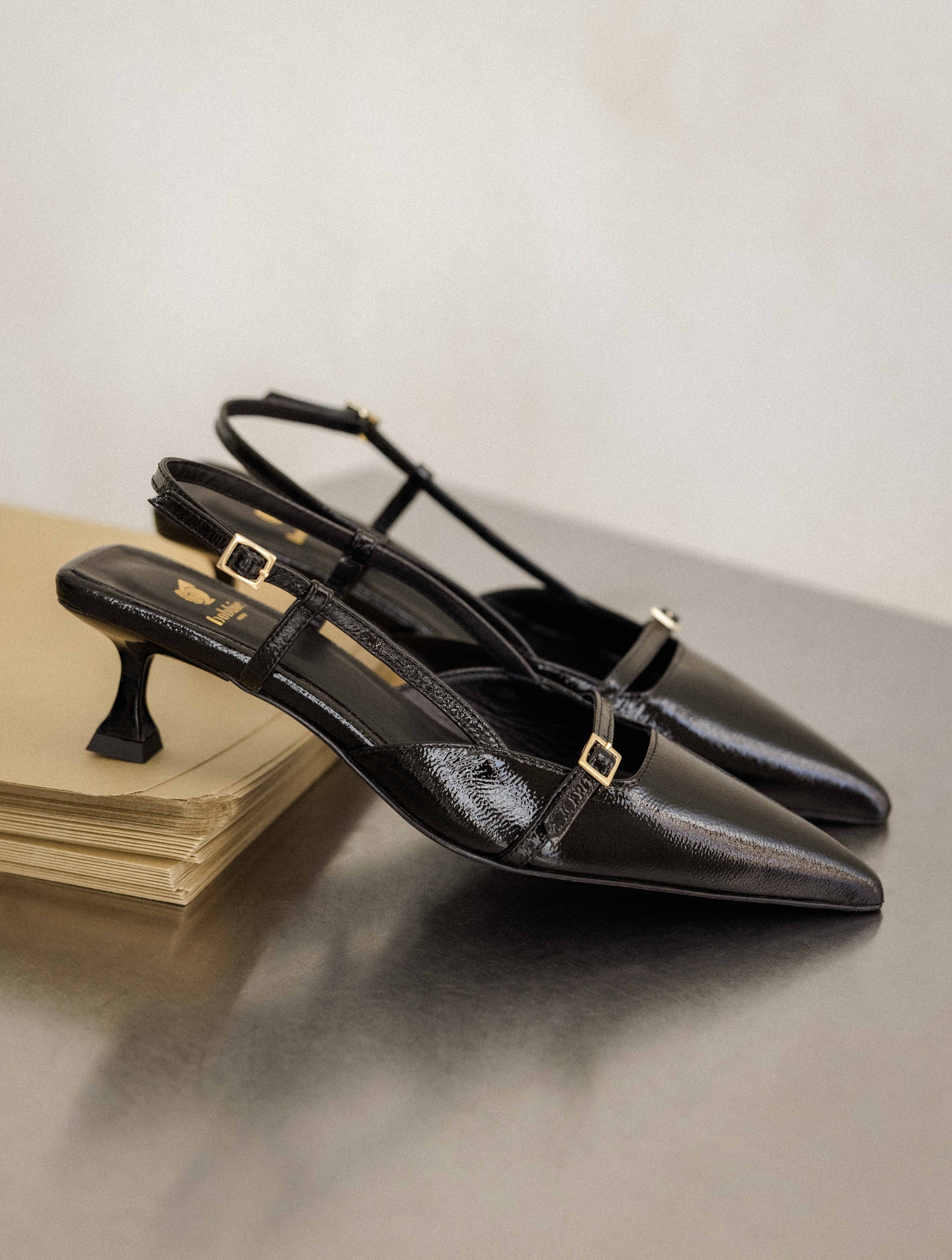 A pair of black slingback kitten heels. 