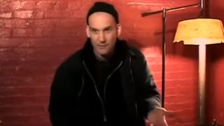 Ian MacKaye being interview in front on a red brick wall in American Hardcore