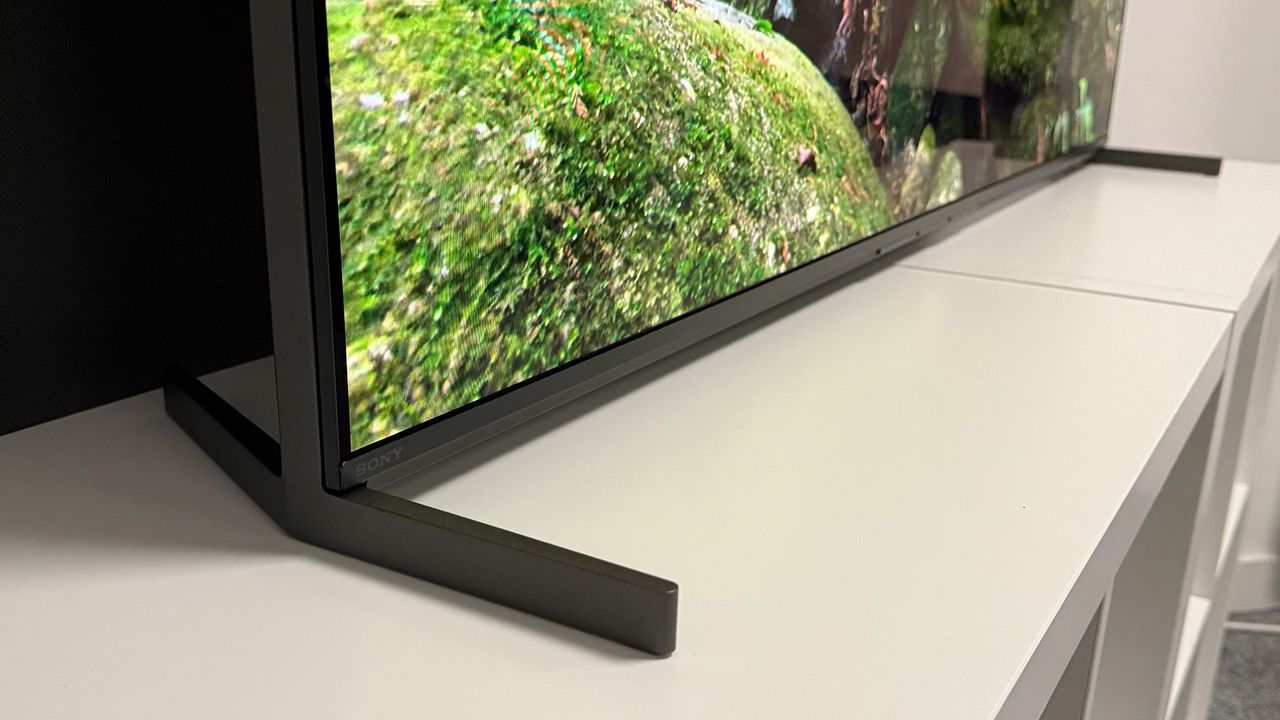 The 55-inch Sony Bravia 8 II QD-OLED TV photographed on a white table. On the screen is a nature documentary.
