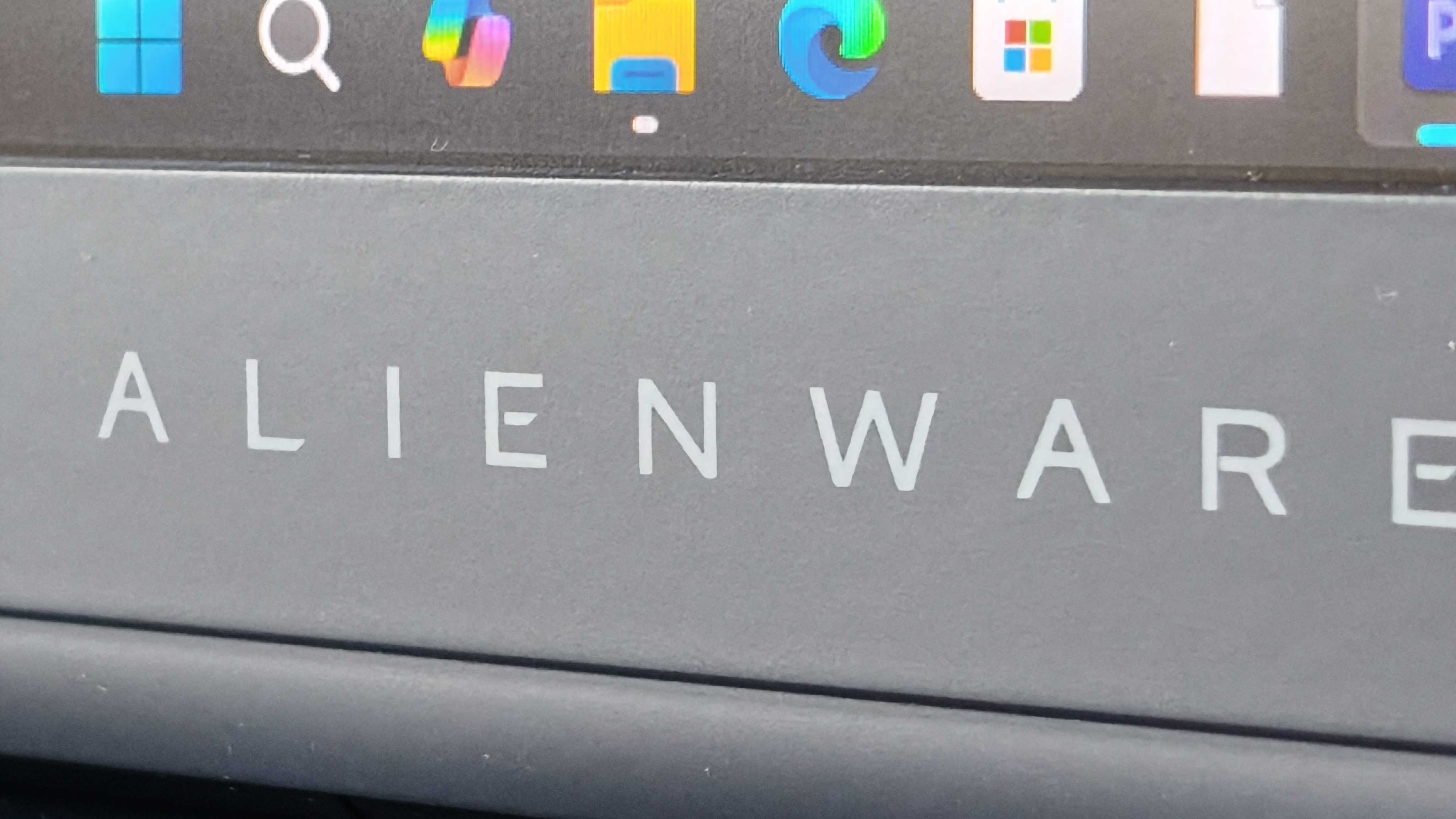 An Alienware 16 Area-51 laptop on a wooden desk