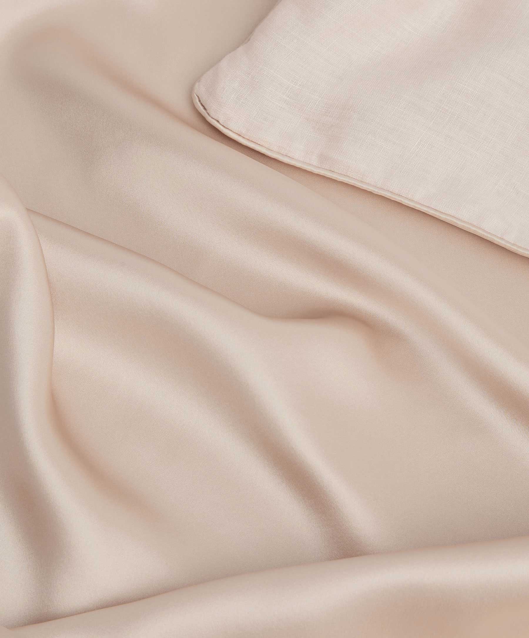 Close-up image of mulberry silk fabric with a bit of linen fabric in the corner.