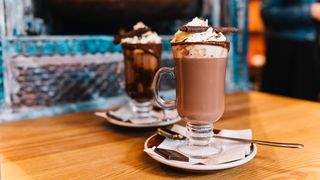 Two decadent hot chocolate drinks on a table