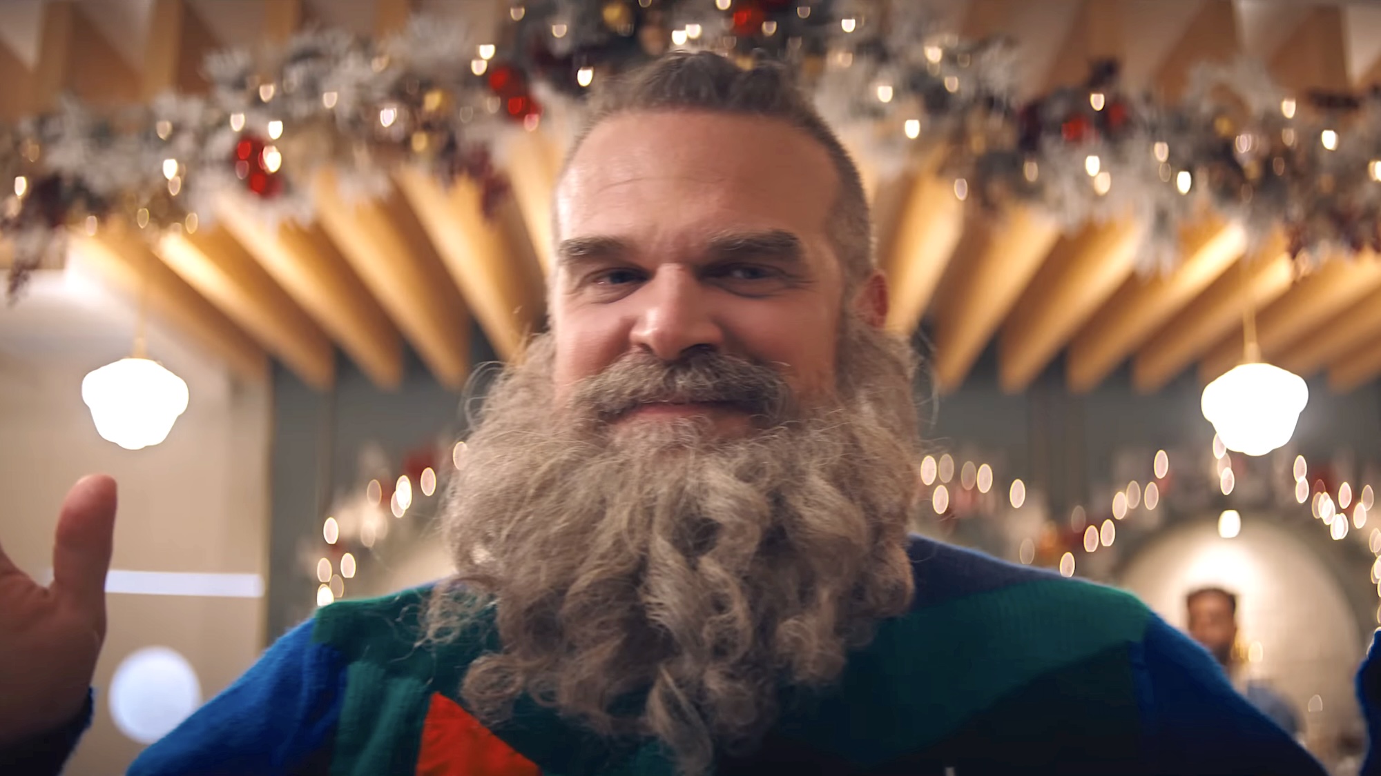 Powerless Saint Nick in Christmas sweater in mall in Violent Night 2