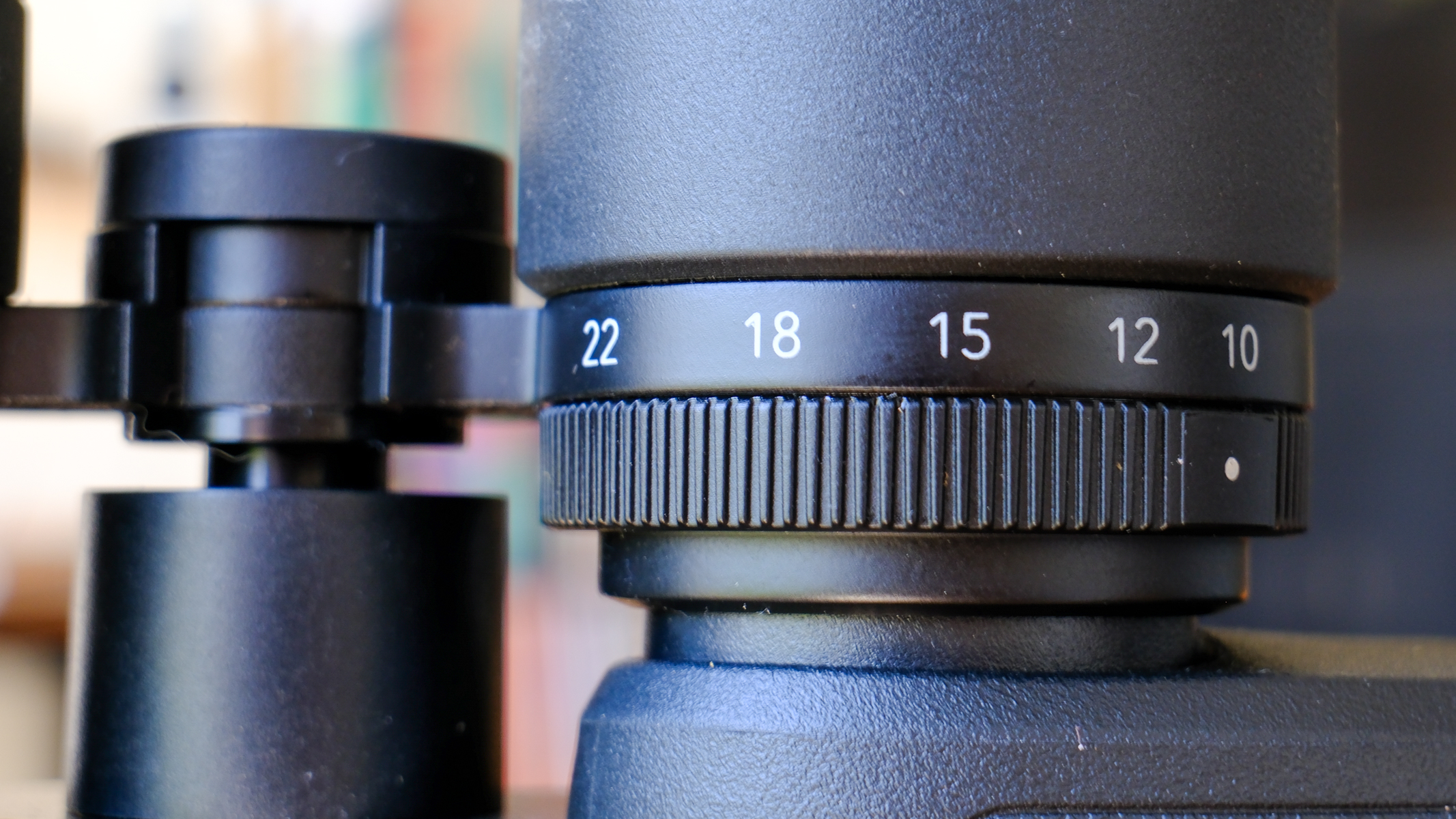 A closeup of the the zoom level ring on the Nikon Action Zoom 10-22x50 binoculars.