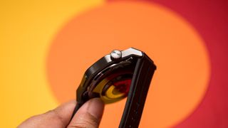 Honor Watch 5 Ultra rotating crown with a colorful background in the back