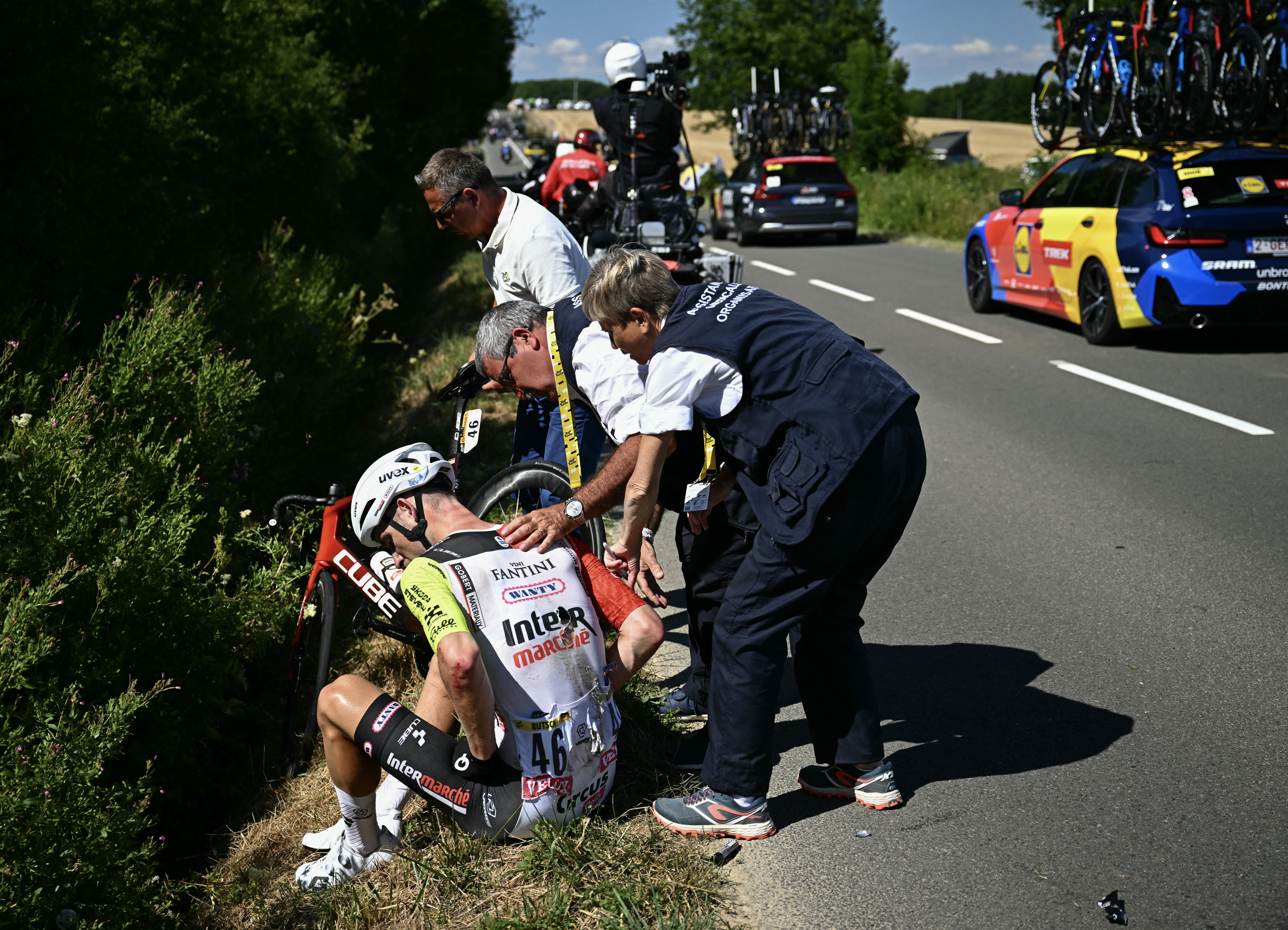 A rider at the side of the road after crashing in a race