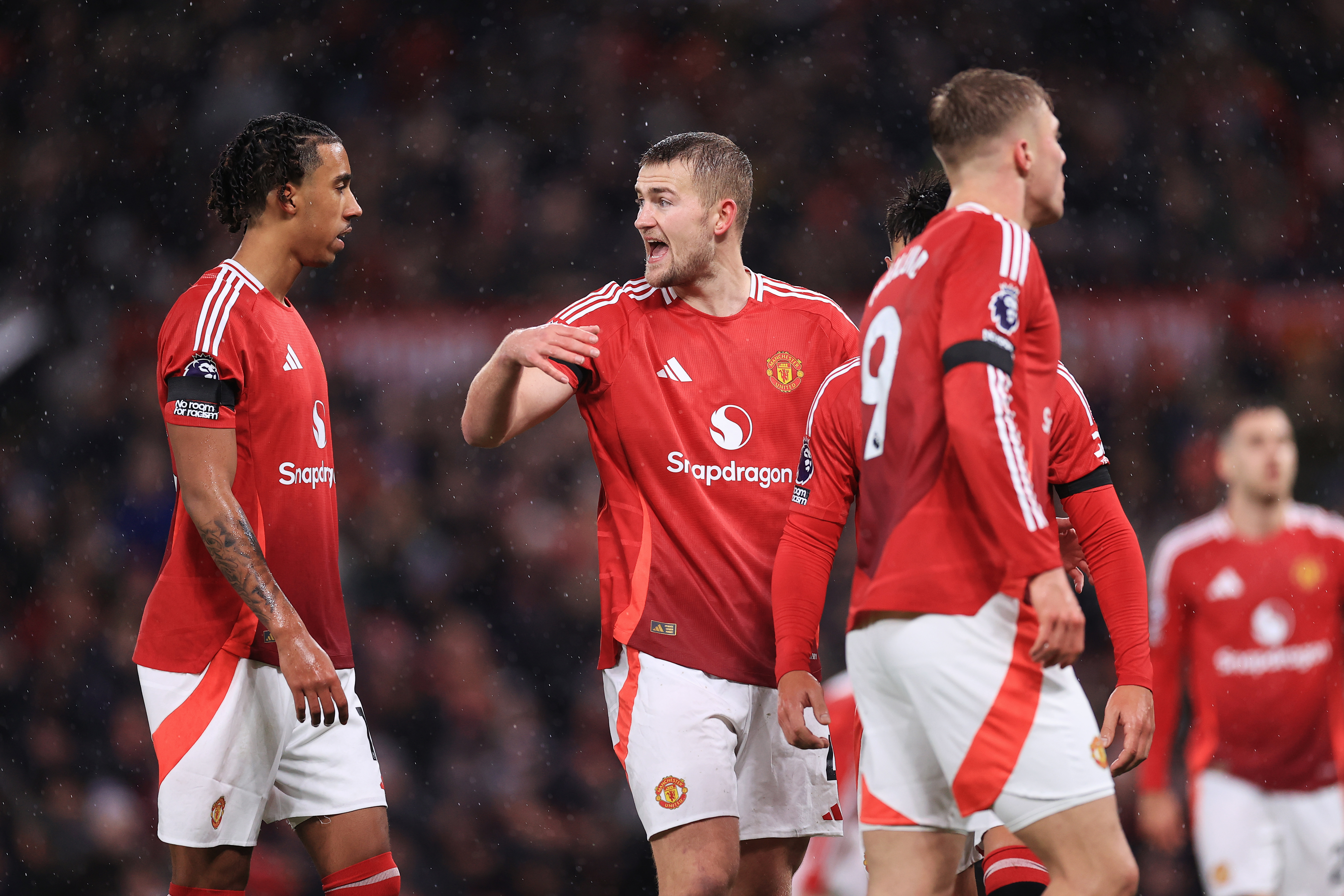 Manchester United's Matthijs de Ligt gestures to Leny Yoro during the Premier League defeat to Nottingham Forest at Old Trafford in December 2024.