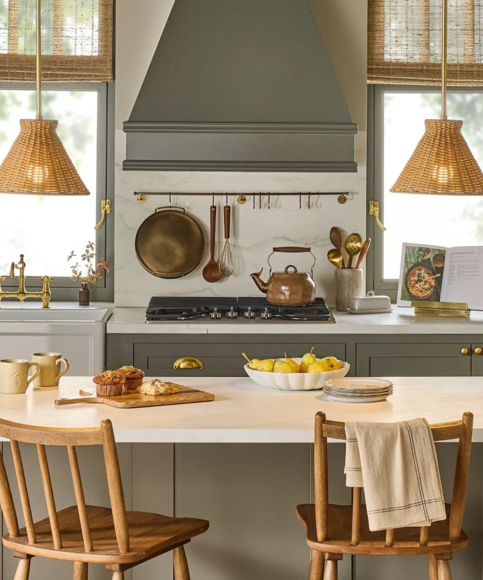 A gray kitchen with white counters and rattan pendant lights