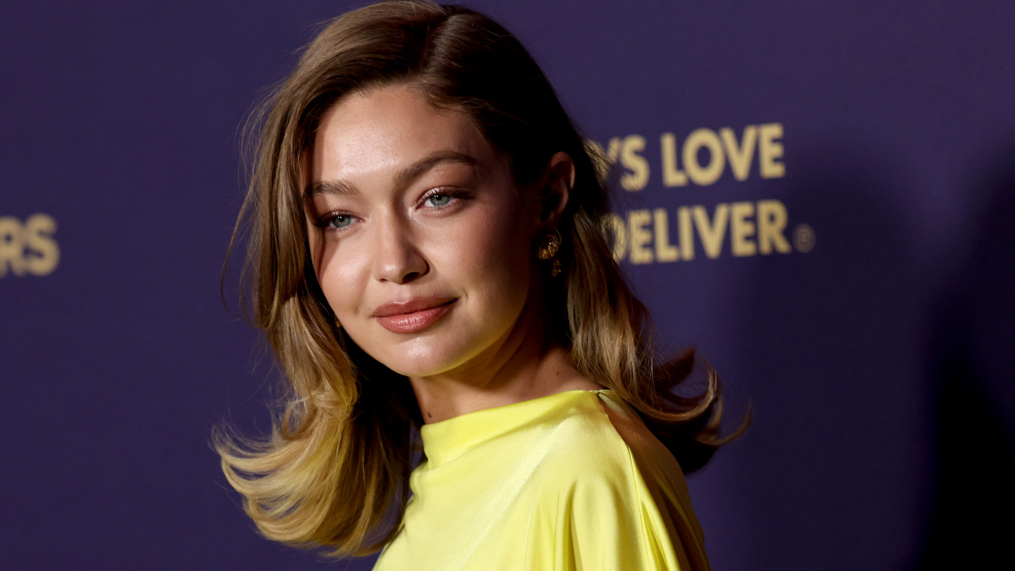 Gigi Hadid wears a yellow dress