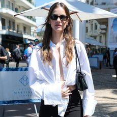 Barbara Palvin wearing a white button-down shirt in Cannes.