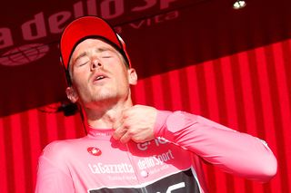 Rohan Dennis zips up the pink jersey after the Giro's stage 4