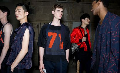 Male models wearing blue and red jackets and tshirts from the Dries Van Noten SS2015 collection