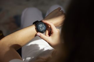 Woman looking at a fitness watch